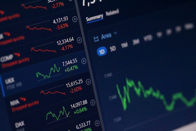 Trader reviewing live market charts on a laptop